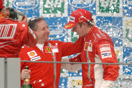 Kimi Raikkonen on the podium with Jean Todt